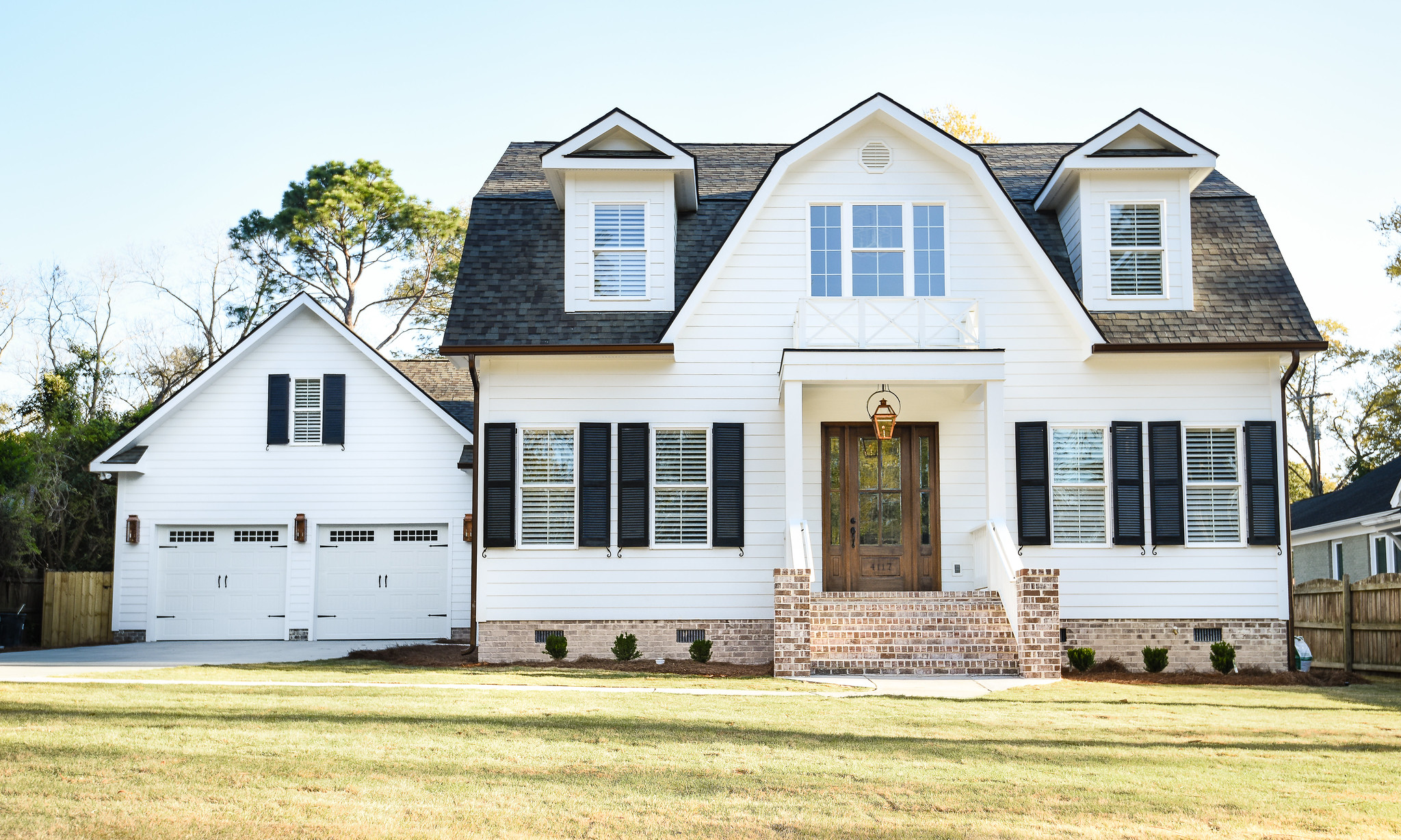 WilsonCo custom white home with black shutters and brick steps in Columbia South Carolina