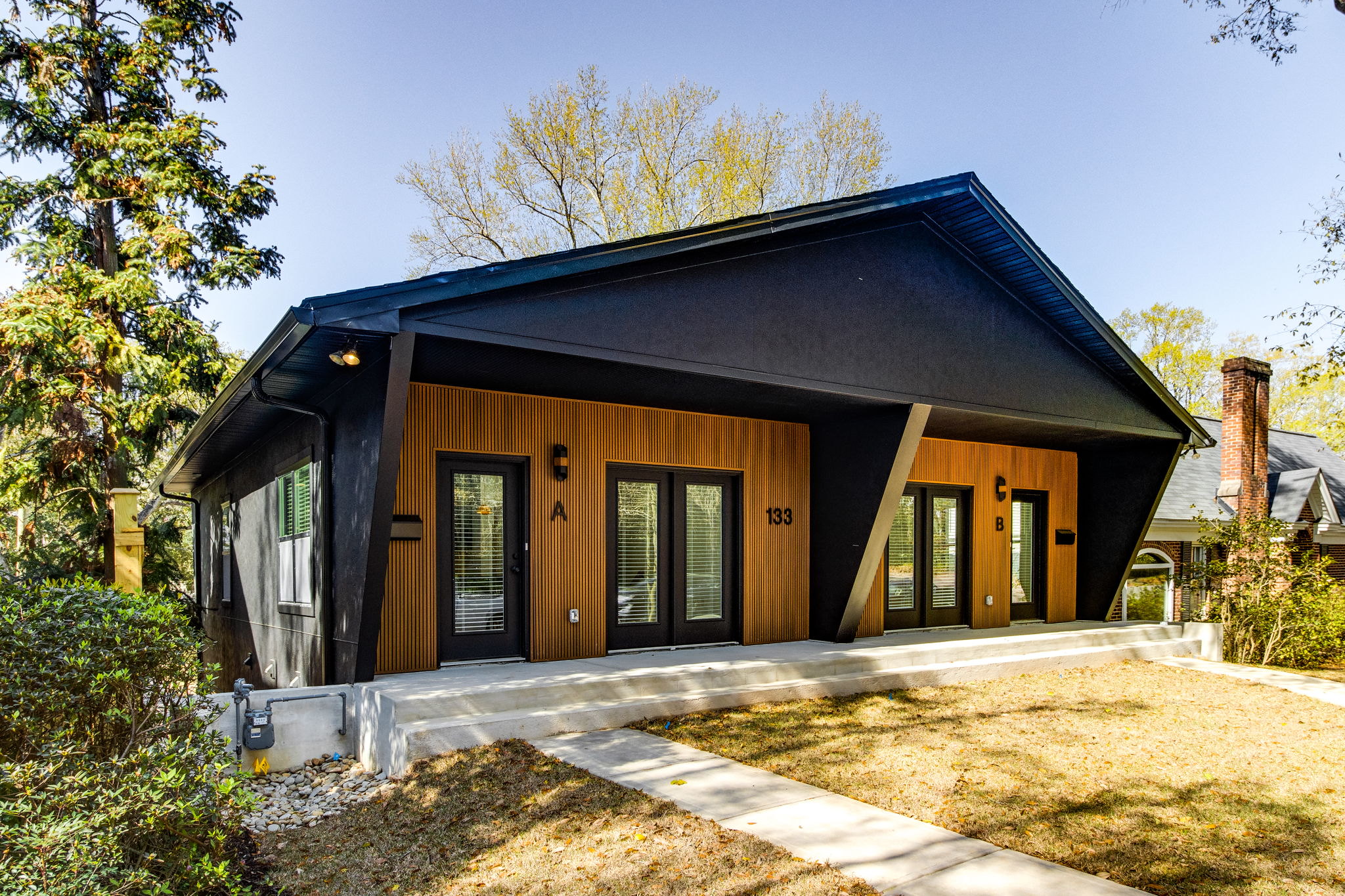 Modern duplex built by WilsonCo with bold black and wood exterior in Cayce South Carolina
