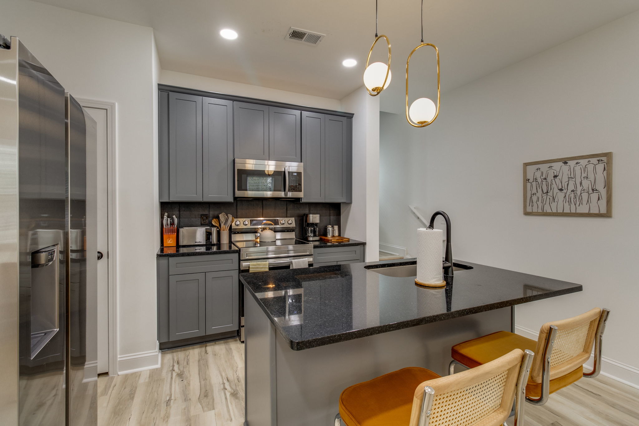 WilsonCo-built modern kitchen with gray cabinets, stainless steel appliances, and island in Cayce South Carolina investment property