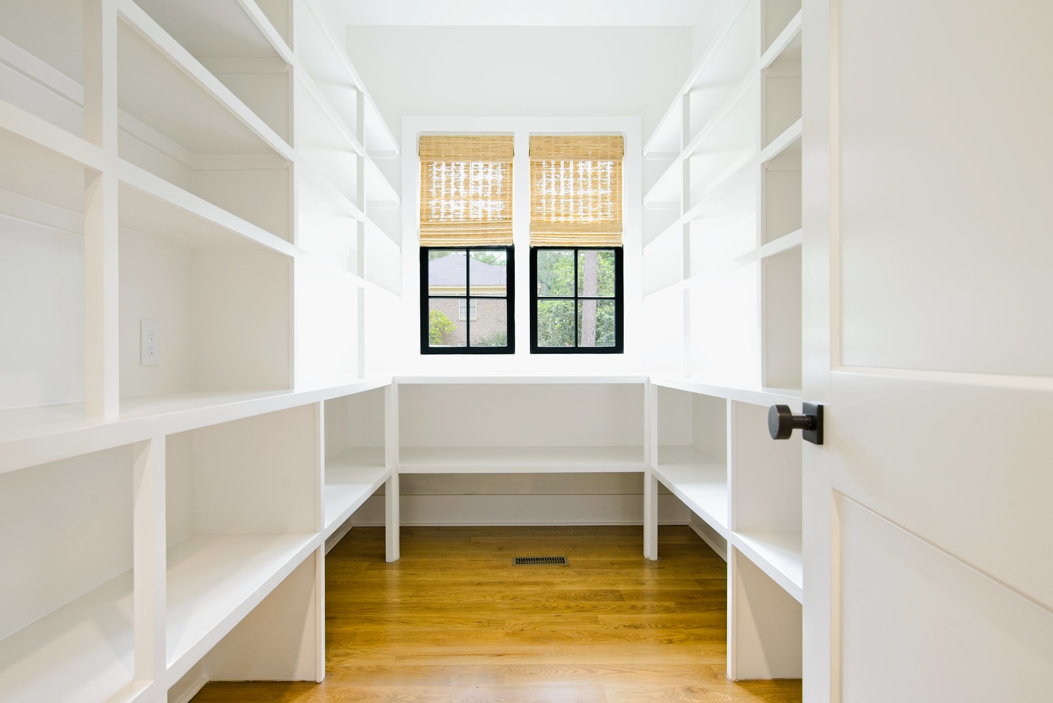 Custom pantry with built-in shelving and wood floors in WilsonCo home Cayce South Carolina
