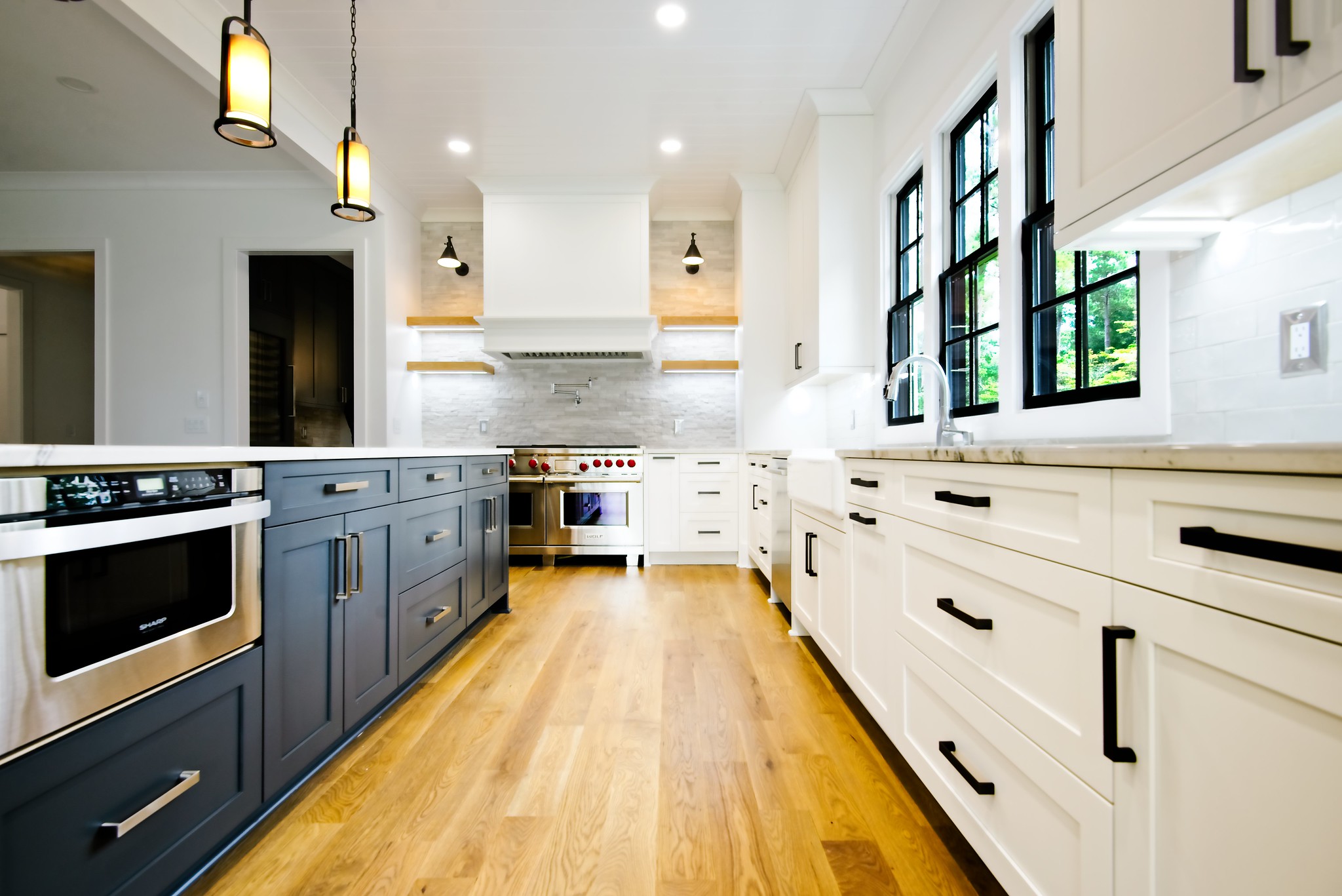 WilsonCo custom kitchen with navy island, white cabinetry, farmhouse sink, and stainless steel appliances in Columbia South Carolina