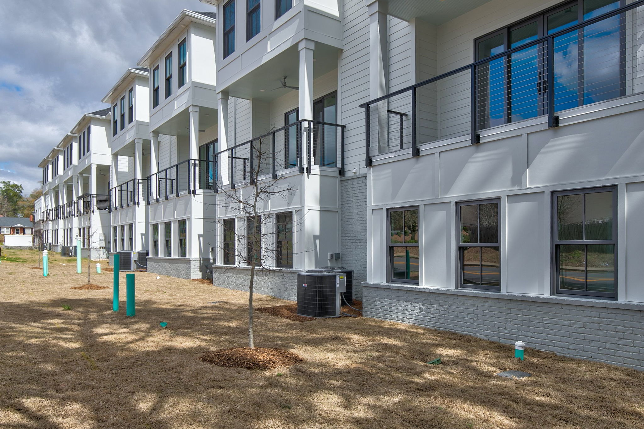 Rear view of WilsonCo-built townhome development with wide porches and large windows in Columbia South Carolina
