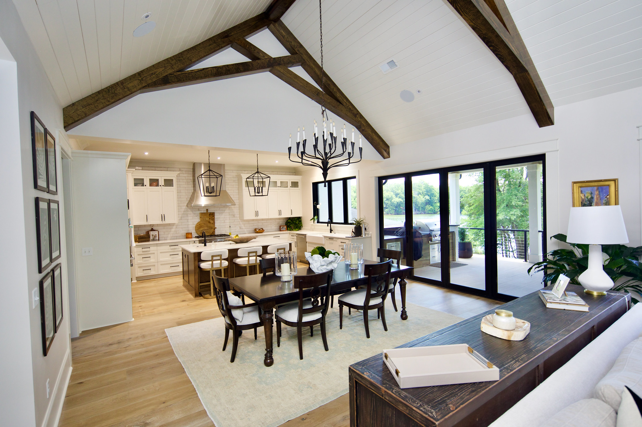 WilsonCo custom kitchen and dining area with exposed beams and full-wall tile backsplash in Columbia South Carolina