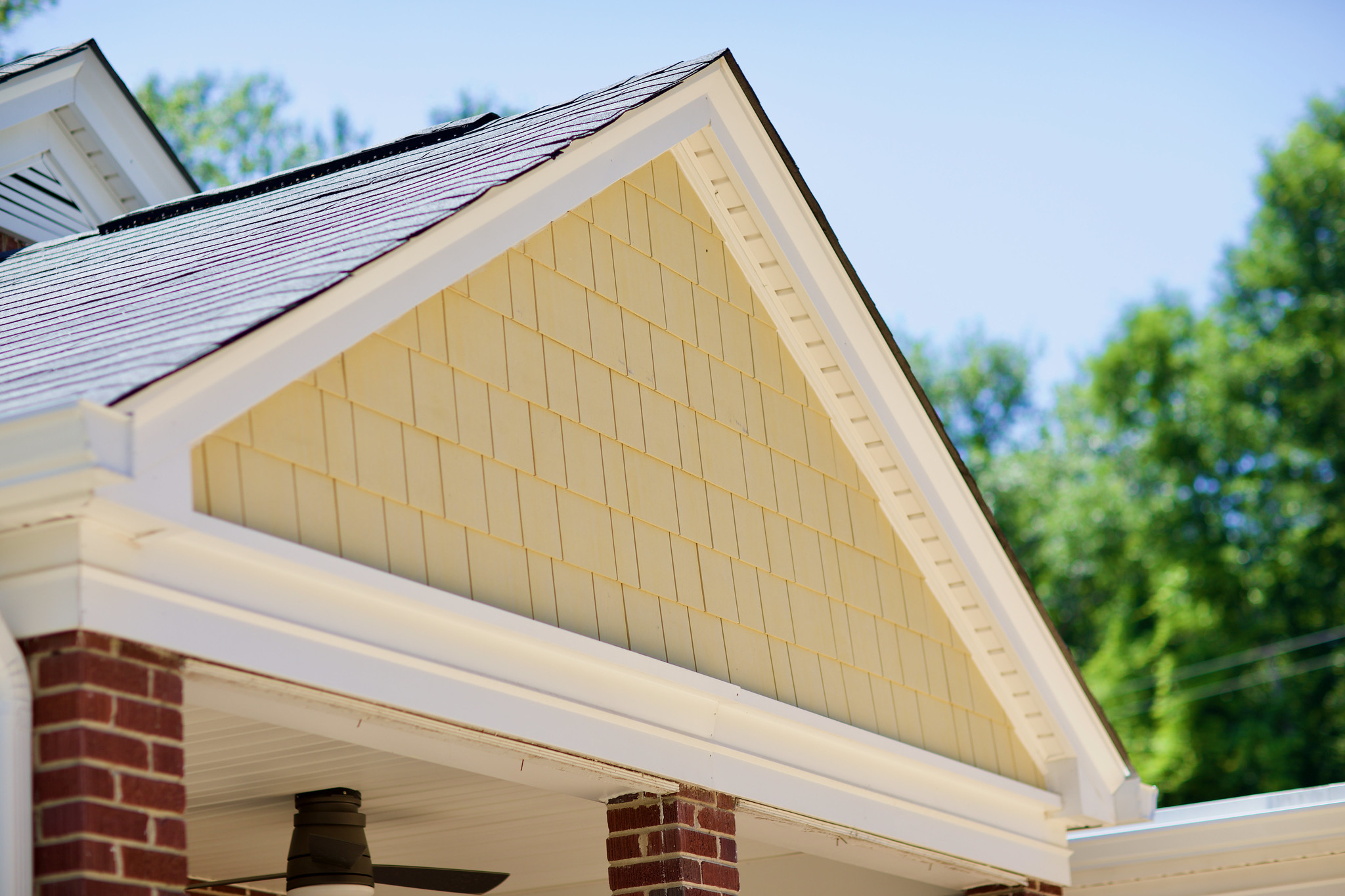 Custom home gable with yellow shake siding and white trim built by The Wilson Company in Columbia South Carolina