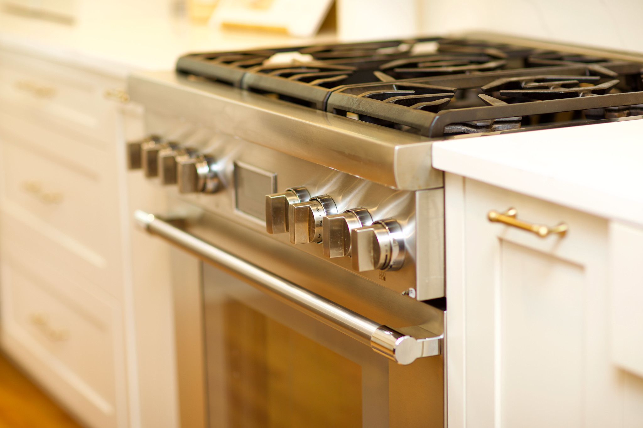 Close-up of stainless steel range knobs in WilsonCo custom kitchen Columbia South Carolina